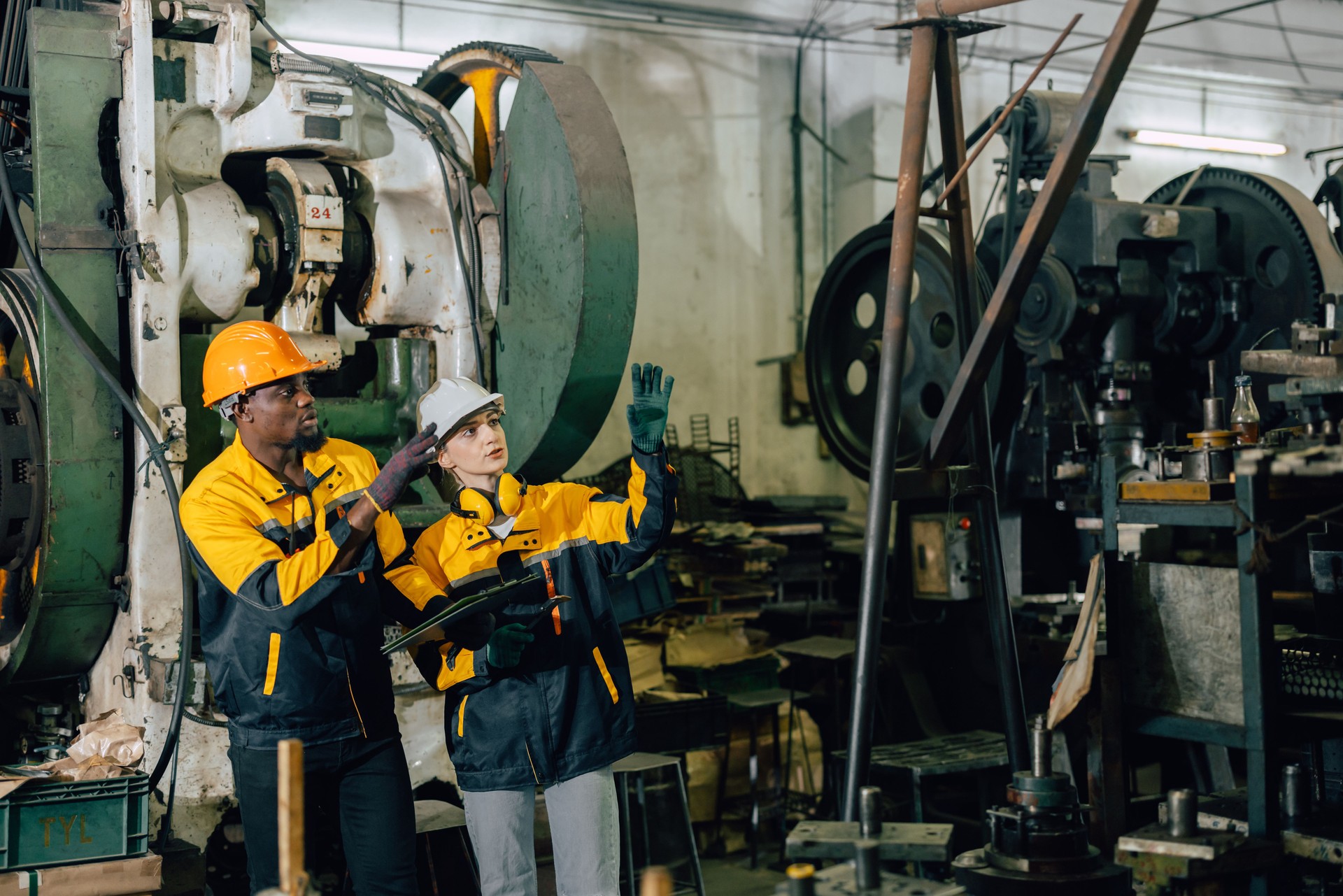 professional engineer team inspecting service machine in heavy industry factory